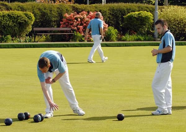 Ballymena bowlers ponder the best route to the jack in Saturday's Irish Senior Cup tie at Randalstown. INBT 22-904H