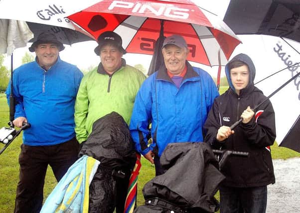Sean McCormick, Gary McWilliams, Andy McWilliams and Jacob managed a smile despite the wet conditions at Galgorm Castle Golf Club. INBT 21-856H