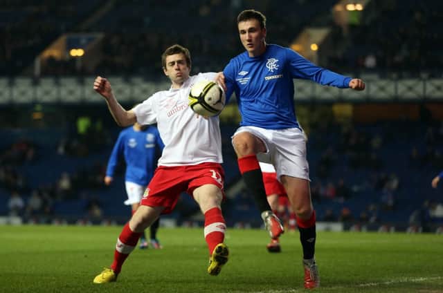 Gary Browne of Linfield competes with Kal Naismith of Rangers during the friendly football match between Rangers and Linfield at Ibrox Stadium in Glasgow, on April10, 2013. PRESS EYE/IAN MACNICOL