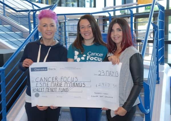 Claire Hudson, Direct Marketing Officer for Cancer Focus N.I. receives a cheque for £2917.50 for the Esme Marie McManus Forget Me Not Fund from Debi Fekkes and Sharon Loughlin. Debi and Sharon took part in a Roller Boot challenge to raise the money. INLT 22-331-PR