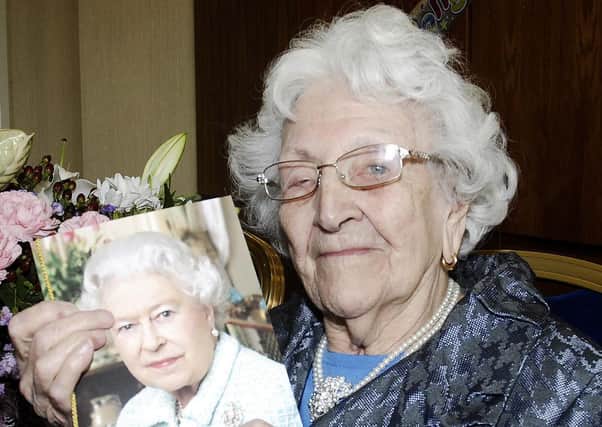 100 Years Young... Gladys Anderson proudly poses with her telegram from the Queen on her special birthday. INLM22-220.