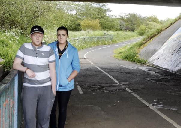 Kyle Magee and Emma McKerr of the Drumgor Detatched Youth Project and Brownlow Youth Partnership. at one of the unlit bridges  and paths in the area. INLM22-242