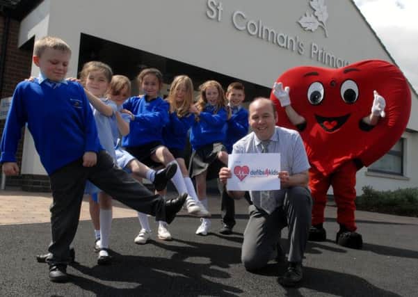 Launching the 'defibs4kids' sponsored walk at St Colmans Primary Lambeg are members of the pupil council along with Mr Art Kernan. INUS2313-STCOLMANSWLK