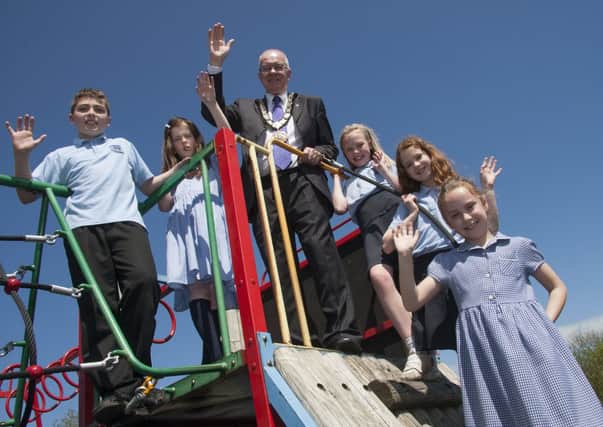 Ballynure PS pupils Chloe Snodden, Grace Owens, Bradley Flynn, Rebecca McKernon and Aimee Strahan with Mayor Victor Robinson at the new and improved play area. INNT 23-516CON