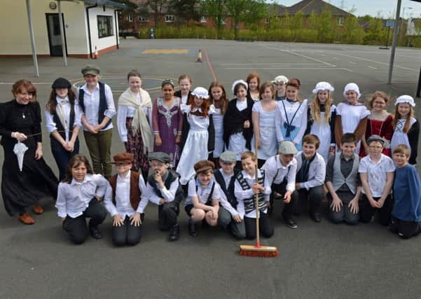 Mossley Primary School teacher Laura Sherwin pictured with P7 room 22 pupils at their Victorian Day. INNT 22-033-PSB