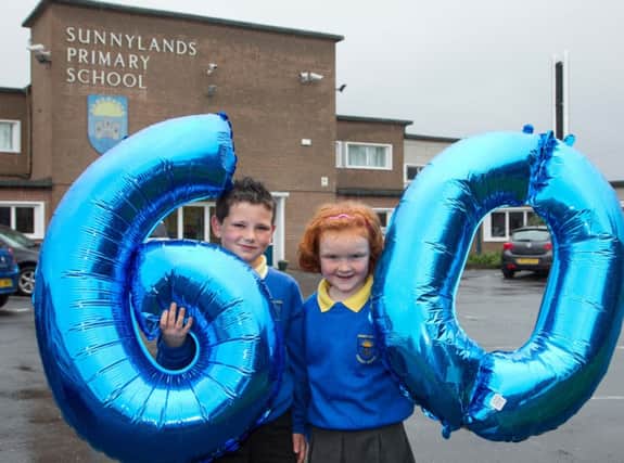 Sunnylands Primary School celebrates its 60th anniversary this year. Pictured with the balloons are P4 pupils Emma McCracken and Thomas Adrain. INCT 23-455-RM