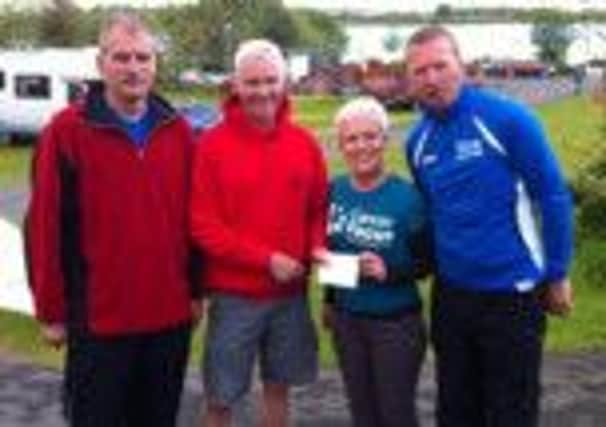 Emma from Cancer Focus presented with Cheque from Magherafelt Harriers