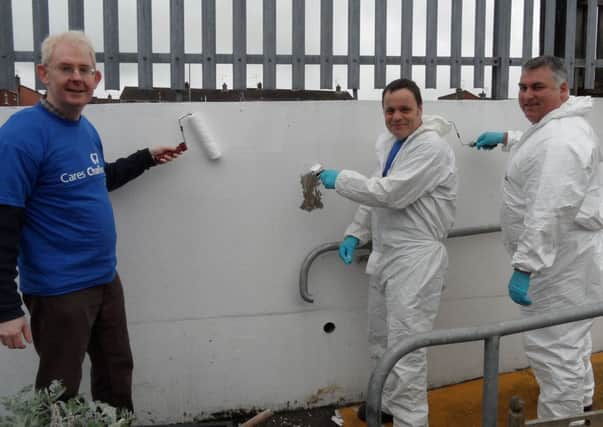 Volunteers from Northern Ireland Water Paul Davison, Martin Lorimer and Sydney Law help give  Waveney Youth Centre a makeover.