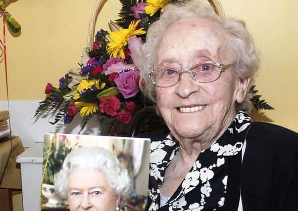 Mrs Lottie Laverty who celebrated her 100th birthday at Mahon Hall Care Home proudly showing off her card from The Queen. INPT24-210.