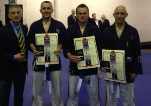 Ballymena men Liam Gordon, Barry Gordon and Barry McCoy who achieved the coveted 3rd Degree Black Belt, pictured with Shihan David Toney.