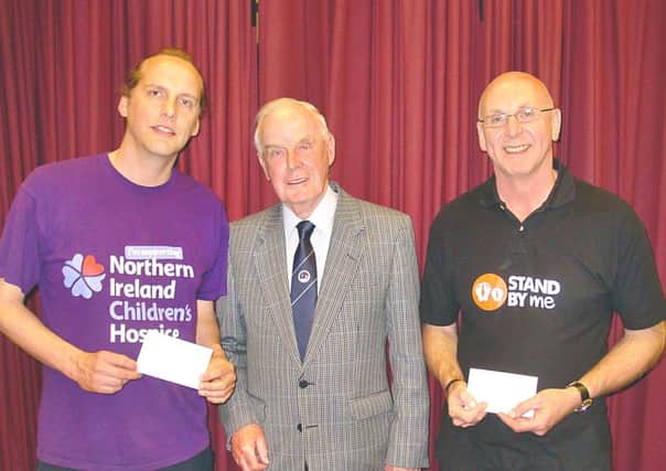 Outgoing chairman Eric Boyd (centre) with Peter McCabe, NI Children's Hospice and Michael Holmes from the Stand By Me charity. INNT 25-511CON