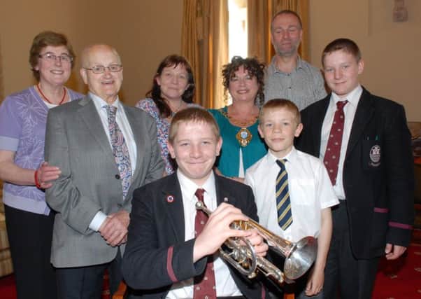 Sam Brodison from Magheramorne pictured with brothers John and Michael and parents Rachel and Nigel, along with Isabel and George Apsley and Larne Mayor Gerardine Mulvenna in the Mayor's Parlour. Sam, who plays with Ballyduff Silver Band, was Best Under 15 in this year's N.I. Young Musician of the Year and 2nd overall last year, also qualifying for the National Brass Band of great Britain. INLT 24-336-PR