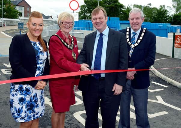 Mr. Terry O'Hern, Chief Executive of the INEA, assisted by the Mayor of Ballymena Councillor Audrey Wales, cut a ribbon to officially open the Ballymena Amenity and Recycling site. Looking are Anne Donaghy, Ballymena Borough Council Chief Executive and Ballymena Deputy Mayor Councillor James McClean. INBT25-857H