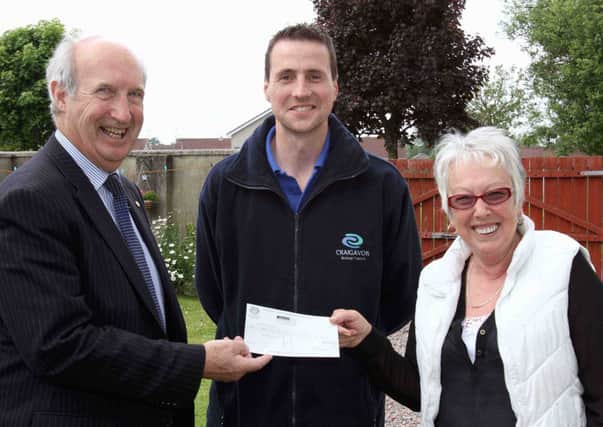 Alderman Arnold Hatch, Chair of the Environmental Services Committee, presents the Craigavon Borough Council Recycler of the Month award for May to Vera Delaney of Garrymore, Craigavon, watched by Recycling Officer Conor Kenny. RicPics. 17/6/13.