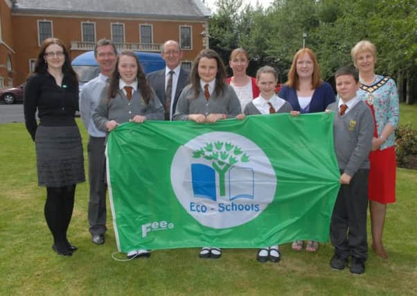 Gilford Primary School pupils along with teacher Miss Paula Martin who were awarded their Eco flag at a celebration day held in Banbridge Civic Buildings. Included are Carmel Fyfe, Eco Schools Tidy NI, David Lindsay, Banbridge District Council, Councillor Brendan Curran, Council chairman Olive Mercer and Tracey Fitzpatrck, environmental education officer. INBL2613-ECO4