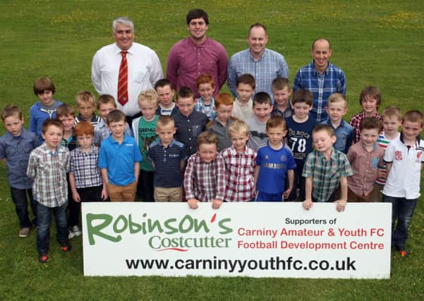 Members of the Carniny Youth Football Development centre at their annual prize giving along with coaches, Davy Boyd, Simon Boyd, Alistair Getty and Ronnie Scott. INBT26-215AC