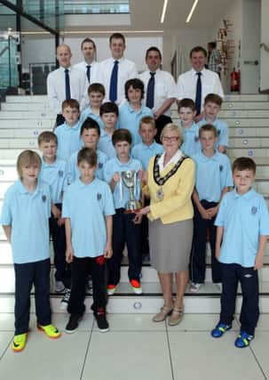 Members of Ballymena United Under 11 team show off their Northern Ireland champions trophy to Mayor of Ballymena, Cllr. Audrey Wales, during a recent reception in The Braid. Included are coaches Colin Lormier, Johnny Hume, Alan McCausland, Andrew Whitbread and Michael Watterson. INBT26-254AC
