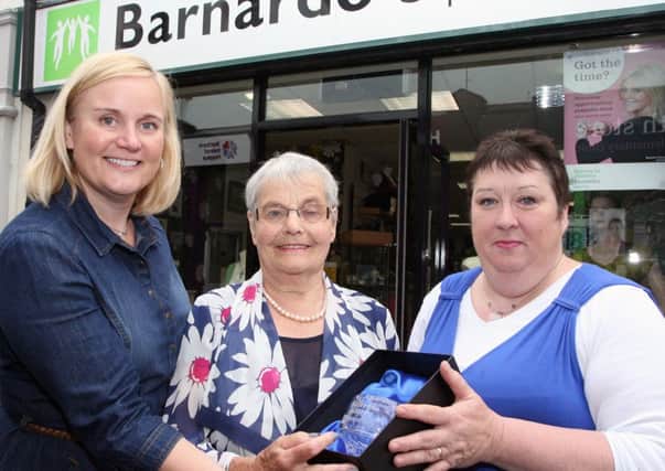 WELL DESERVED. Ruby Wray (centre), who has been a Volunteer at Barnardo's for twenty years, pictured receiving a Rose Bowl to mark her years of service from Sarah McCotter, Manageress and Communications Manager Anne Dawson (left).CR26-334SC.