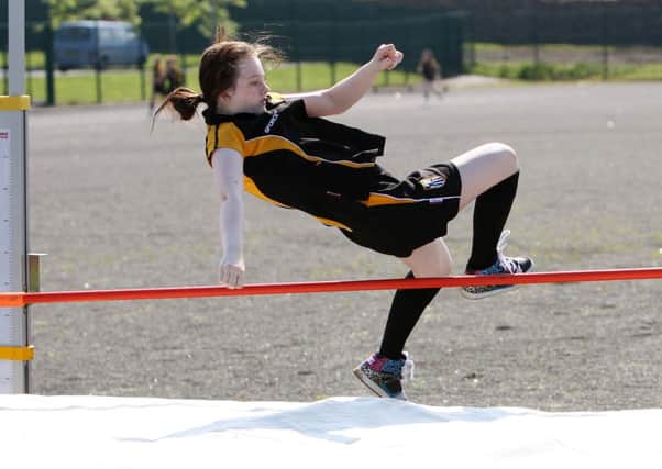 Dunclug College pupil Rebecca Blayney clips the bar during the year 9 high jump. INBT24-212AC