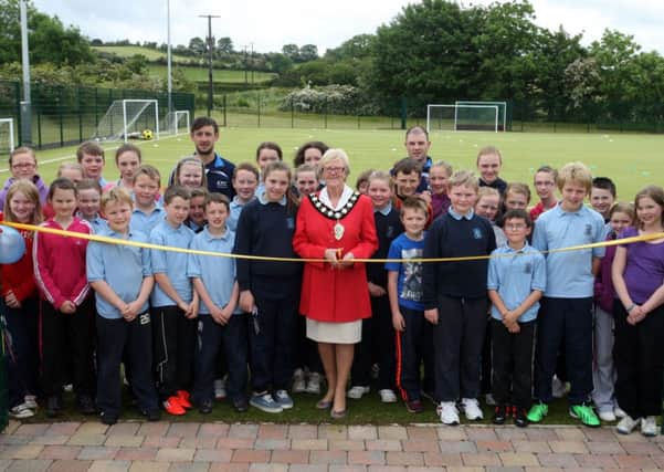 Mayor of Ballymena, Cllr. Audrey Wales, along with pupils from Clough PS and Kirkinriola PS cuts a ribbon to open the new football facilities at Clough. INBT26-228AC