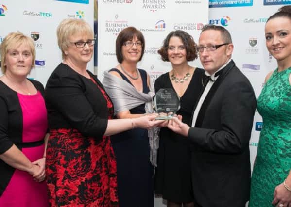 Linda Parke, Philomena Deery, Joan Gallagher, Mary Crumley from Derry Credit Union, winners of the Healthy Workplace Award, sponsored by Public Health Agency through Derry Healthy Cities     at the Derry ~ Londonderry Business Awards, receive their award from Brendan Bonner and Sabrina Dunne, Derry Healthy Cities. Picture Martin McKeown. Inpresspics.com. 13.06.13