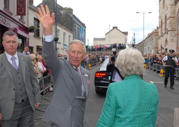 Prince Charles waves to the crowds in Larne. INLT 26-486-PR