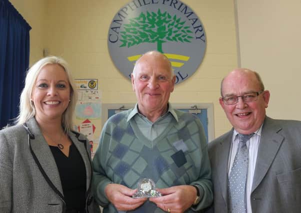 Dawson Campbell (centre) who last week retired as patrol man at Camphill Primary School is seen here with school principal Mrs McMaster and chairman of the Board of Governors Henderson Ballentine. INBT 27-105JC
