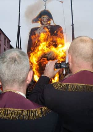 Onlookers capture the scene on their mobile phone cameras as the effigy of Lundy the Traitor goes up in flames on Saturday. LS49-112KM