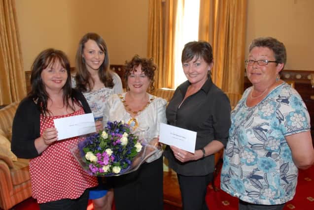 The Mayor's Ball held in the Town Hall raised over £3500 for the Mayor's charities of Women's Aid and the Alzheimer's Society Prom Friendship Group. Pictured receiving the cheques are Fay Tilson and Caroline Skelton from Women's Aid and Louise Magill and Maggie Taggart from the Prom Friendship Group. INLT 24-342-PR