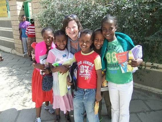 Karen Salmon with some of the orphans she helps through the Crosslinks programme in Ethiopia. INNT 27-605con