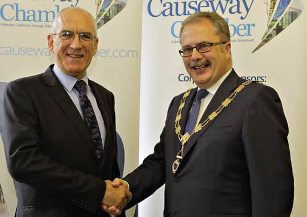 The new President of the Causeway Chamber of Commerce Mr Ian Donaghey (right) being congratulated on his appointment by outgoing President Mr James Smyth.