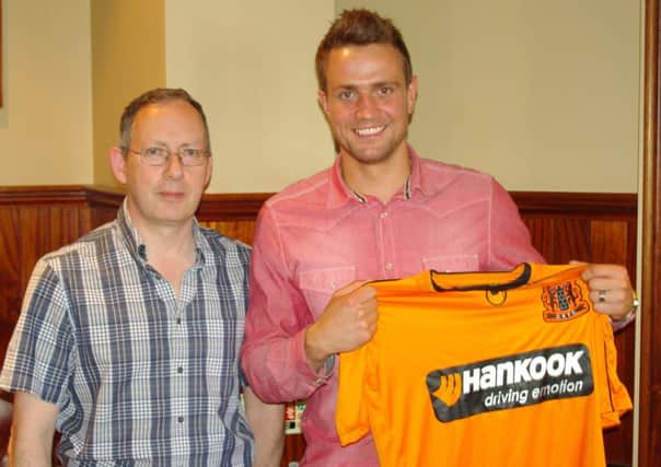 New signing Richard Gibson with club director, Peter Clarke.