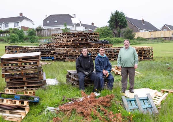 Cllr John Scott with two of the volunteers who helped move the bonfire to the new site. INCT 27-406-RM