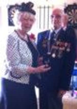Lord Lieutenant of Co Antrim, Joan Christie OBE, presents the Arctic Star medal to war veteran Isaac Higginson. INNT 27-527CON