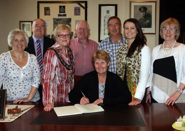 Jill, Gregg and Hanna Quayle, from New South Wales, Australia, are pictured signing the visitors book in The Braid during recent reception with the Mayor of Ballymena, Cllr.Audrey Wales. They are over in Ballymena visiting their cousins Janice Thompson, Michael Thompson and Isobella Thompson. Included is Cllr. Martin Clarke. INBT28-200AC