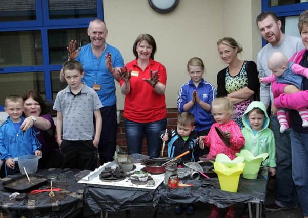 MUDDY WATERS.Parents, boys and girls and staff at Surestart get all muddy during a learning workshop at Culraith Corner.CR28-301SC.