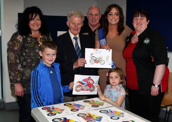 Ald. Maurice Mills and Miss Mid Antrim Zoe McKinnan, who judged the Mid-Antrim 150 primary schools art competition, hold up the two winning entries (both from Moorfields PS), which will feature in the 150 programme. Included are Seamus Dobbin (Chairman Mid-Antrim), Jenny Morrow (Mid-Antrim), Jonathon McMullan, Elaine McMullan (Moorfields PS teacher), and Misha McKinnen. INBT28-216AC
