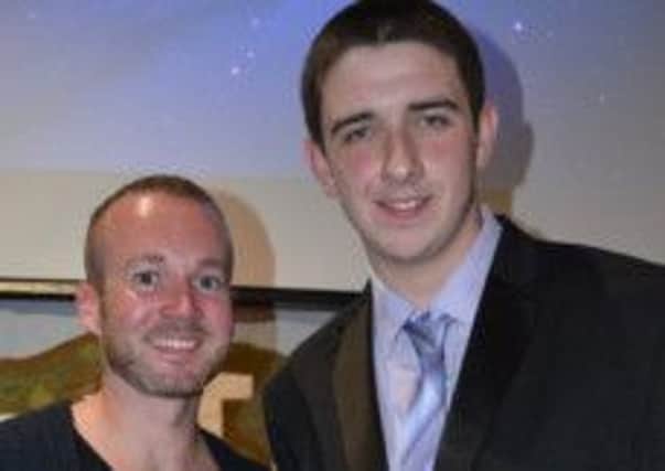 Stevie McKay pictured receiving his 'Rookie of the Year' volunteer award by Trevor McDaid, Youth Initiative youth worker.