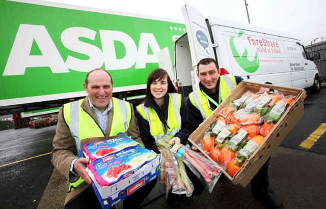 Simon Geddis (left) from Fareshare collects the first donation of food from Asda's main depot in Larne. The food - which includes chilled and fresh ranges - will be redistributed amongst local charities to support those who are struggling, vulnerable or at risk. Helping Simon to load the Fareshare van are Kelly Cooke, Senior Stock Clerk, Asda Depot, Larne and Justin Vaughan, Contracts Manager, Asda, Larne. INNT 28-511CON