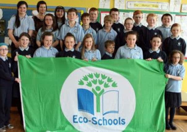 ECO KIDS. Teacher at St Joseph's PS, Mrs McCarry pictured with pupils with the ECO Flag.INBM26-13 130SC.