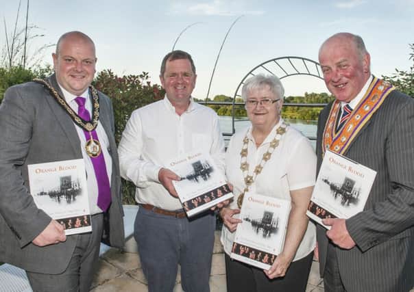 Pictured at the launch of 'Orange Blood' are (L-R) Mark Baxter,
Mayor of Craigavon; photographer Boyd McClurg; Olive Whitten, Grand
Mistress of the Association of Loyal Orangewomen of Ireland; and
Edward Stevenson; Grand Master of the Grand Orange Lodge of Ireland.