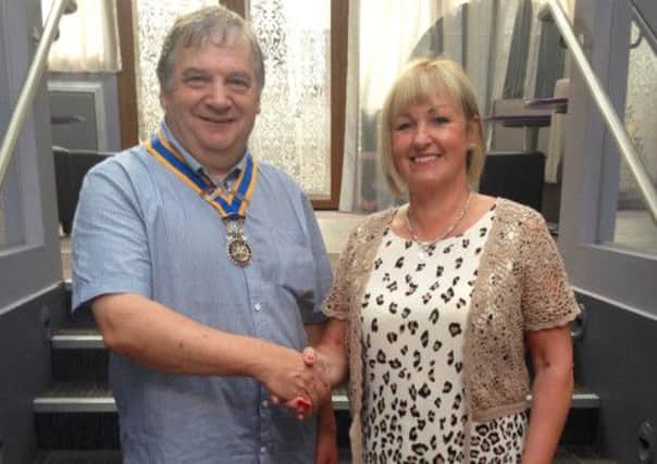 The outgoing President of Ballycastle Rotary Club Angela Bonar welcomes incoming President Jim Boylan. INBM29-13s