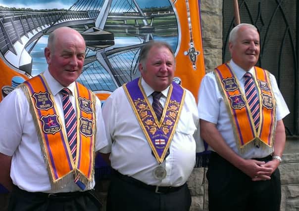 Twelfth visitors to Londonderry, the UK City of Culture, are, from left, Wor Bro Edward Stevenson, Grand Master of the Grand Orange Lodge of Ireland, Most Wor Bro Ron Bather, Grand Master of the Grand Orange Lodge of Scotland and Most Wor Bro Henry Dunbar, Grand Master of the Grand Orange Lodge of England. They are pictured in front of the new City of Londonderry Banner, dedicated last week and on parade for the first time today.