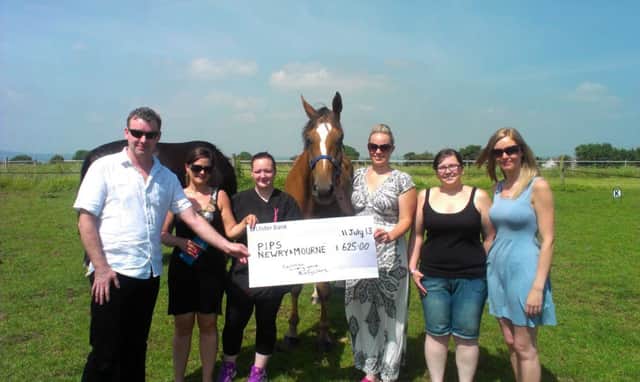Pictured at Cairnview Livery Yard near Ballyclare are Eamon Murphy (PIPS Newry & Mourne) receiving a cheque from Talitha Collins, Stephanie Watson, Nikita Cochrane, Katie McClay, Lynsey Wilson and Shelly Boyle.  
The girls raised(£625.00 through participating in the Belfast Marathon Fun Run 2013. The girls focussed on this challenge following the loss of their good friend Eimear in February of 2013 . Eimear orginated from Newcastle in Co.Down and this was why the girls chose the charity PIPS Newry & Mourne.
PIPS Newry & Mourne extend gratitude and thanks to the girls on they,re efforts to give hope to other individuals through their kind donation. PIPS Newry & Mourne provides a range of free services to the community, such as Counselling, suicide prevention and awareness training and information, bereavement support and much more on a daily basis. If you wish to know more about their work, or need further information on the issues, please visit www.pipsnewryandmourne.org .INLT 29-601-CON