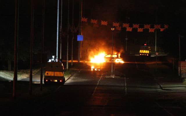 Police were attacked with paint bombs and petrol bombs during Tuesday night's violence on the O'Neill Road. At least two vehicles were burnt out during the disturbance. INNT 30-600con