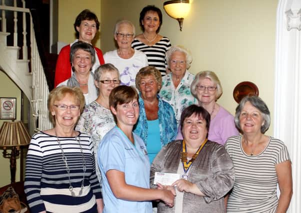 Mary Waldron, President of Ballymena Inner Wheel, presents a cheque for £324 to Jenny Wilson of Antrim Area Hospital for the purchase of three nebulisers for patients use in the community. Looking on are Inner Wheel members.  INBT30-201AC