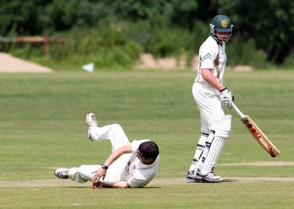 Ballymena bowler Simon McDowell dives to make a catch against the North Down batsman. INBT30-228AC