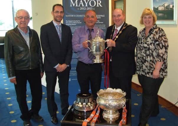 Pictured with the Irish League Gibson Cup and the Iru Bru League Cup to promote the upcoming friendly match between Crewe United and Cliftonville on the 30th July are: (l-r) Mr Tom McKenna, Chairman of Crewe United; Thomas McKenna, Manager of Crewe United; Tommy Breslin, Manager of Cliftonville and former Crewe United player; the former Mayor of Lisburn, Alderman William Leathem and the former Mayoress, Kathleen Leathem.