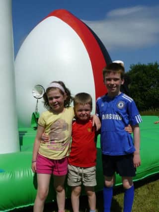 Ethan, Madison and Caleb McFadden get ready to check out the giant inflatables at The Diamond.
