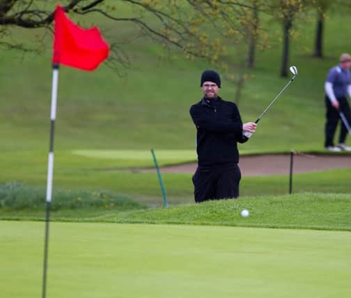 A golfer in action at Lurgan Golf Club.